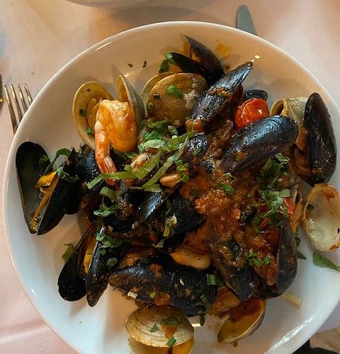The Palazzo Restaurant signature dishes Agnello Stinco, Ribeye, Seafood Pescatori.